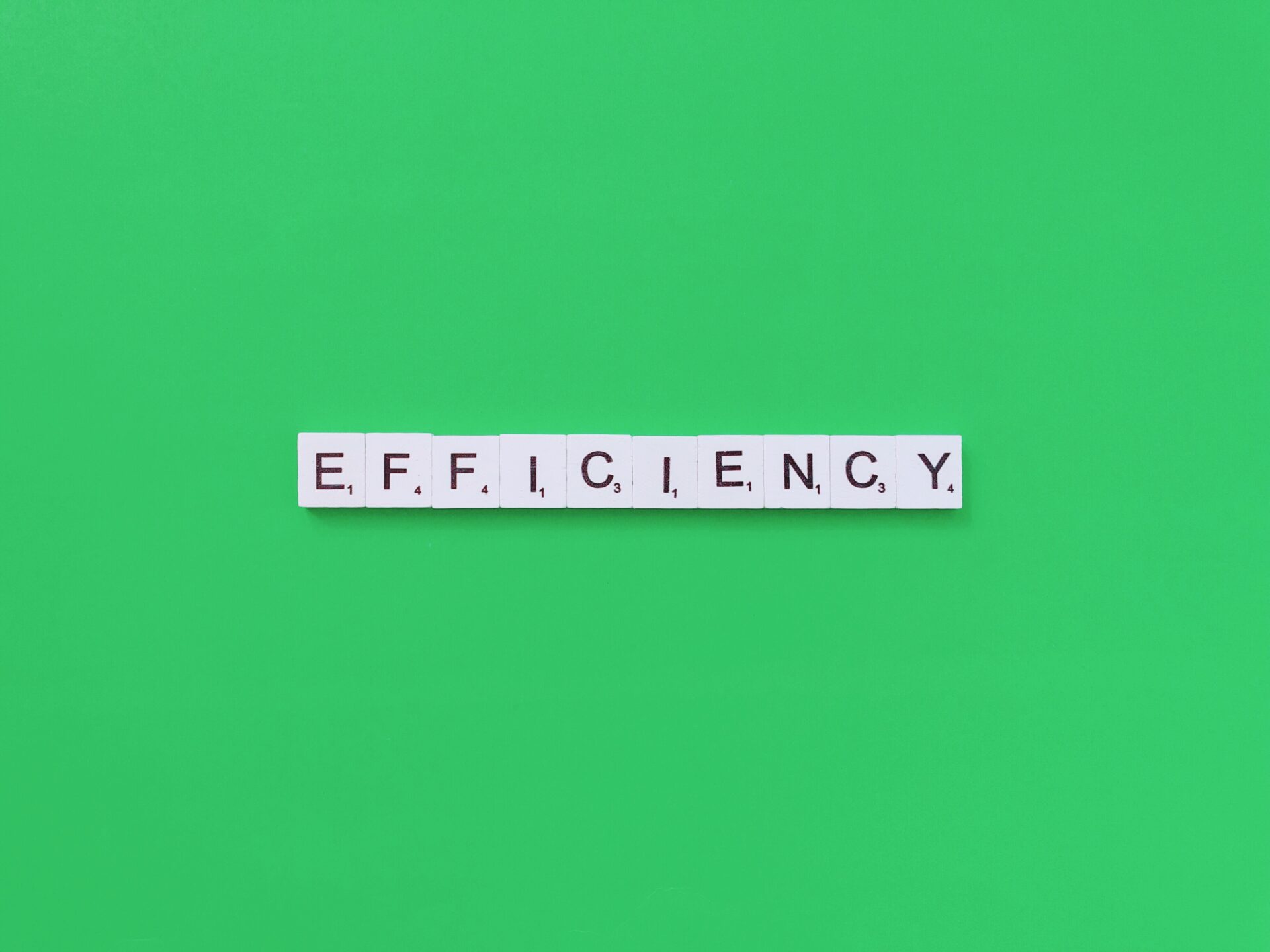Image of blocks spelling out 'Efficiency,' highlighting workflow optimization, healthcare analytics, integrated healthcare, and care coordination.