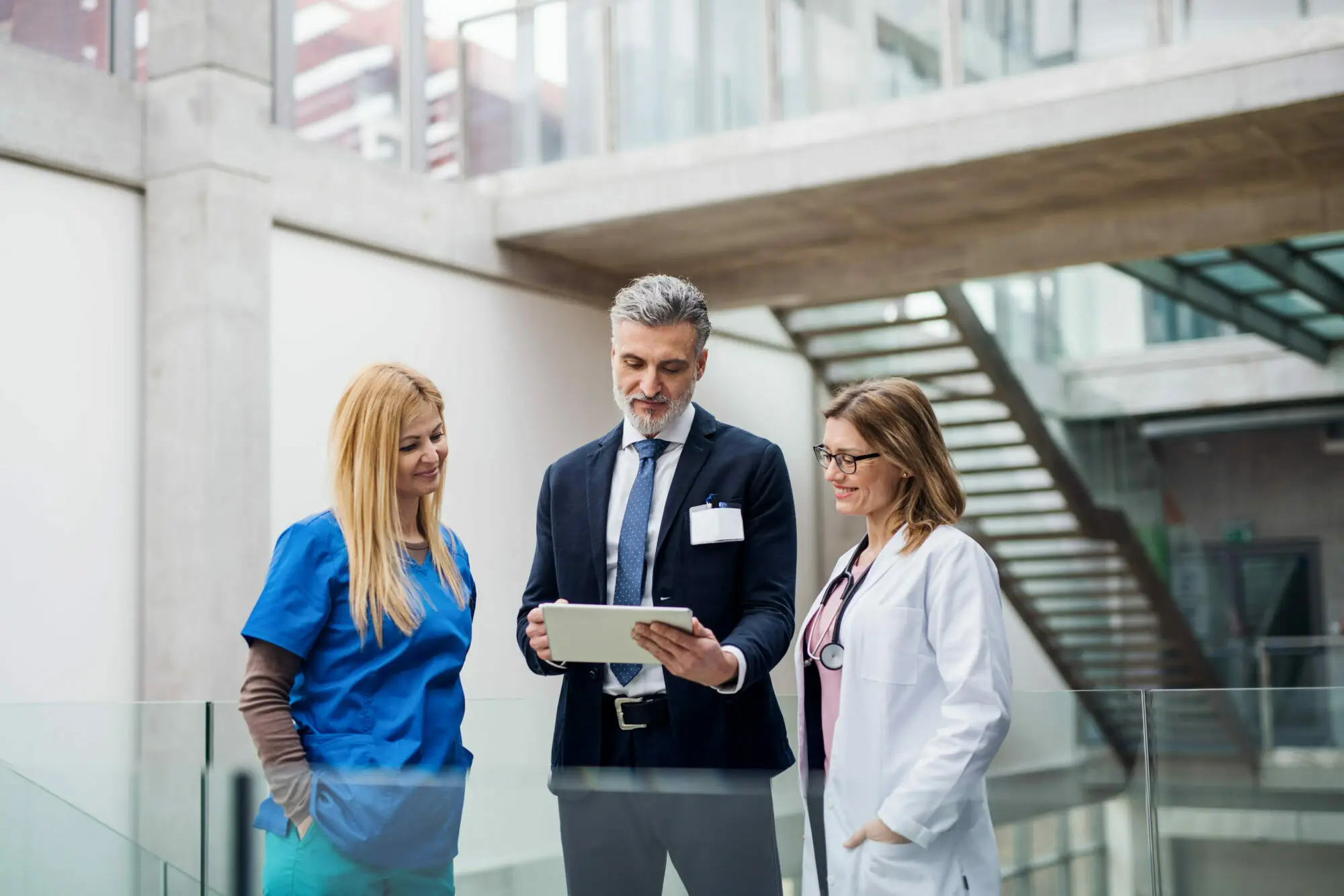Group of doctors talking to a medical device sales representative, highlighting healthcare communication, medical inventory management, care coordination, and integrated healthcare.