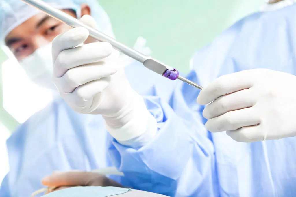 Screw, drill, gloves - Surgical team celebrating a successful procedure using HUB Healthcare, highlighting care coordination, healthcare communication, integrated healthcare, and patient management software.